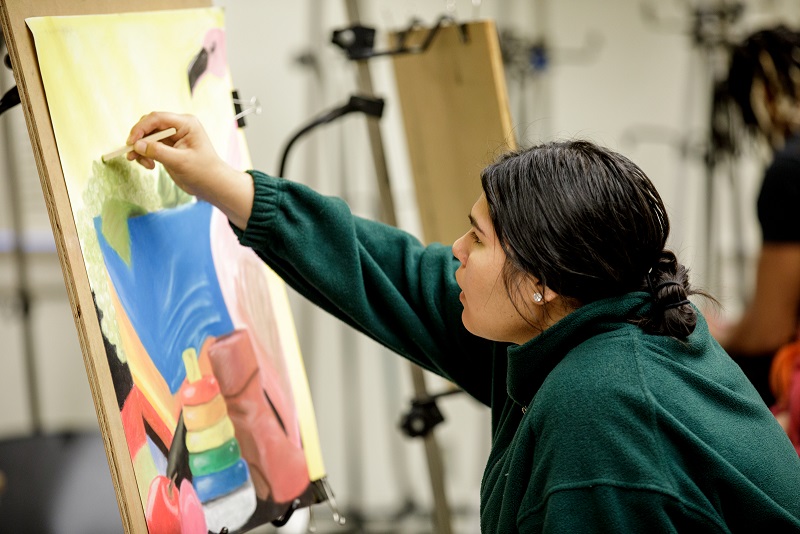 A student draws with pastels