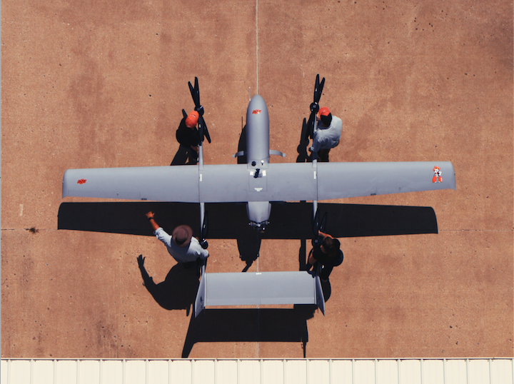 Students carrying OAIRE muggin from hanger