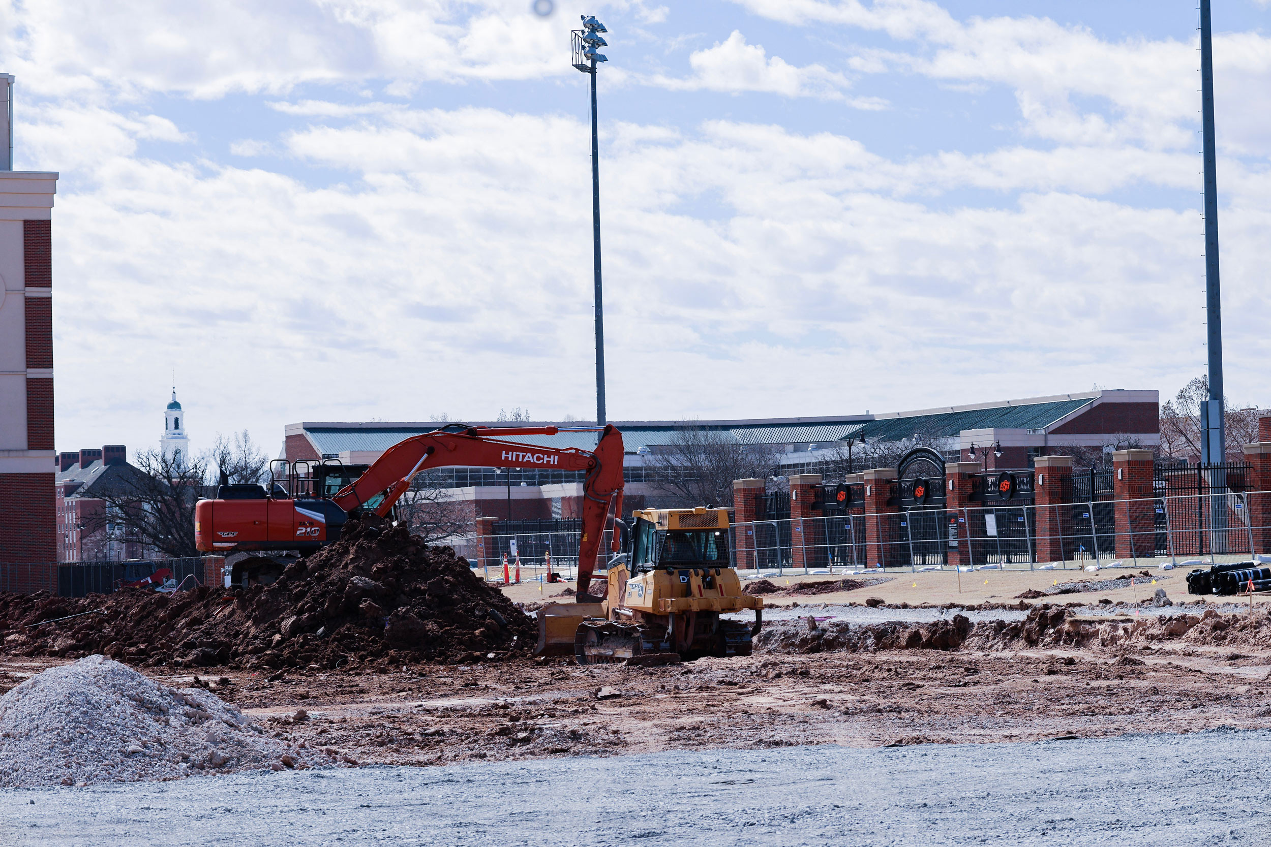 an excavator and bulldozer move dirt to prepare a for building construction
