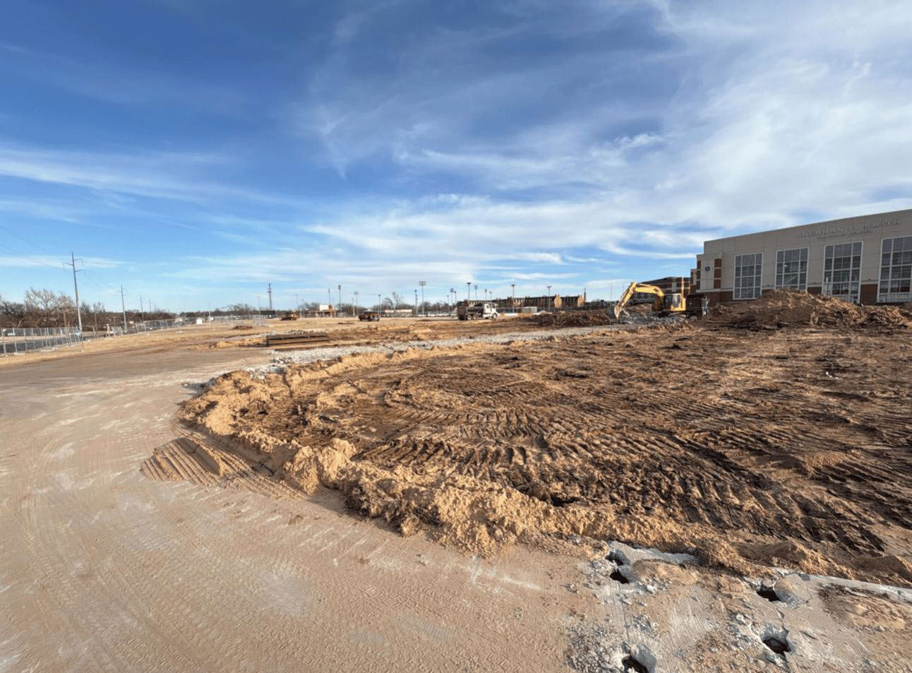 an excavator is moving dirt in preparation for a new building construction
