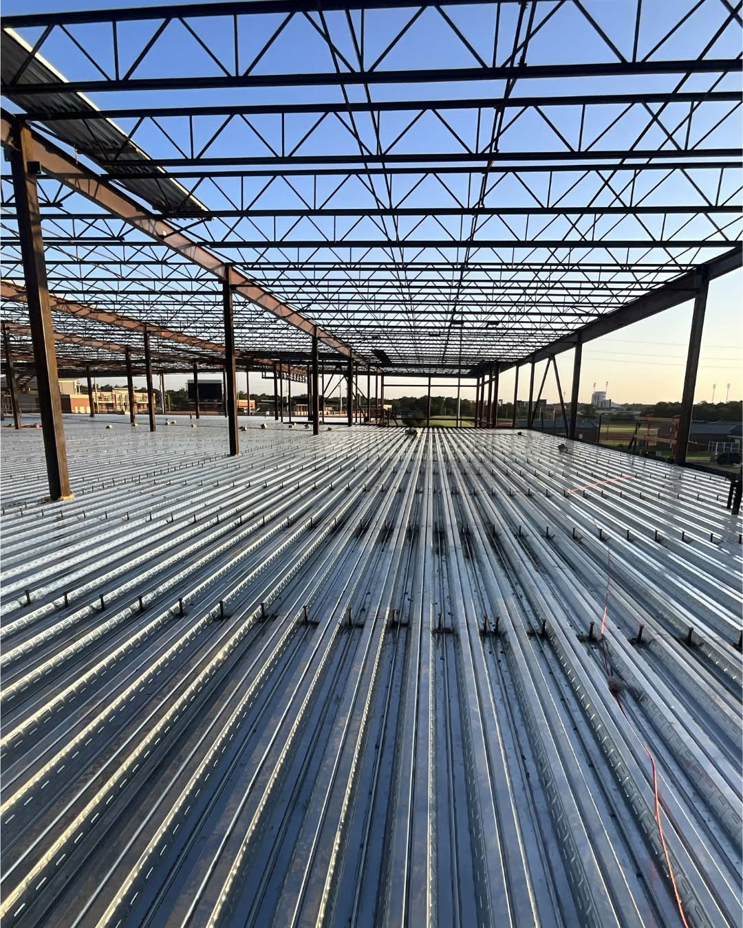 Steel framing and corrugated metal decking installed during construction of the Boone Pickens Human Performance Innovation Complex at Oklahoma State University.