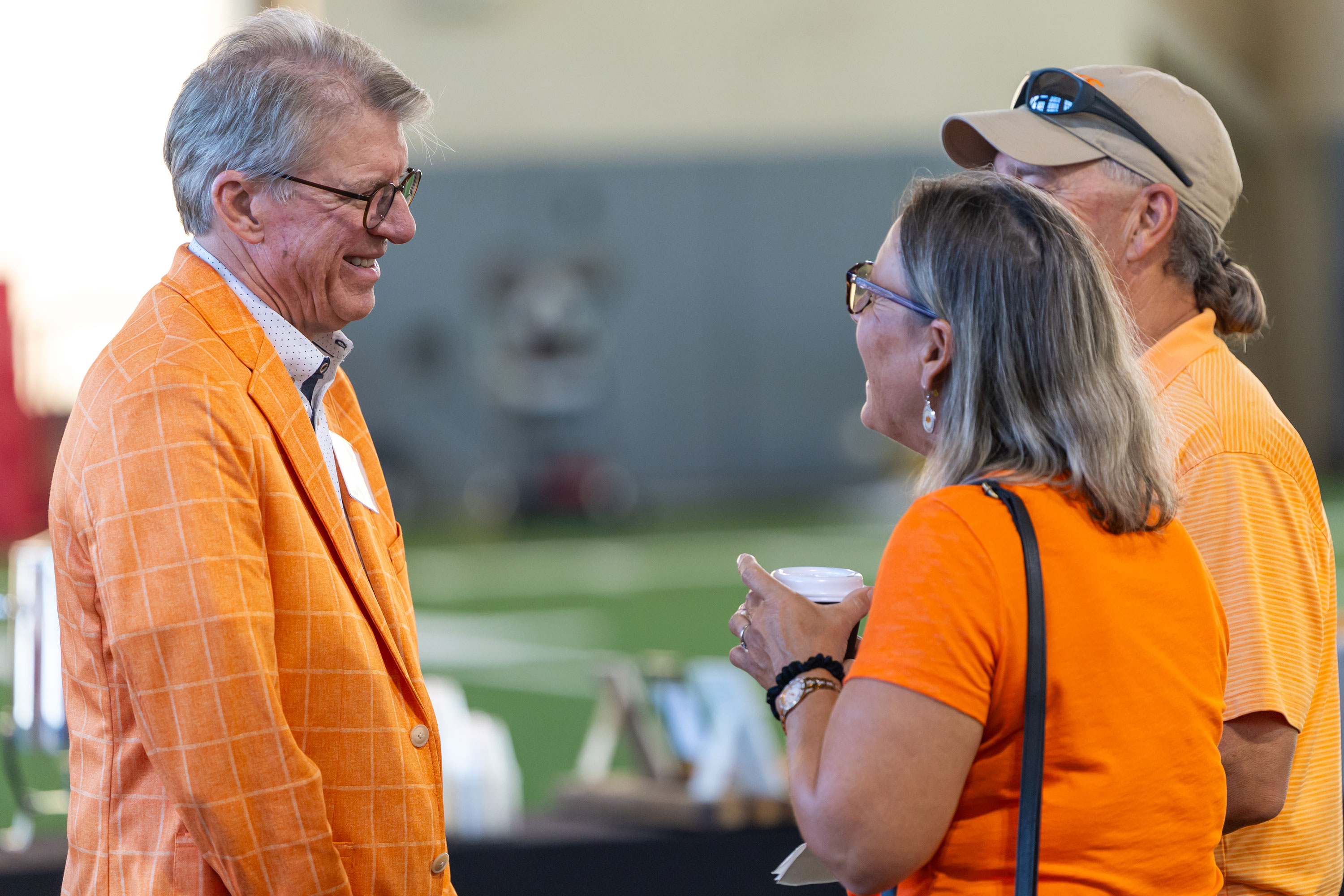 President Jim Hess speaks to two OSU supporters at the HPIC topping off ceremony