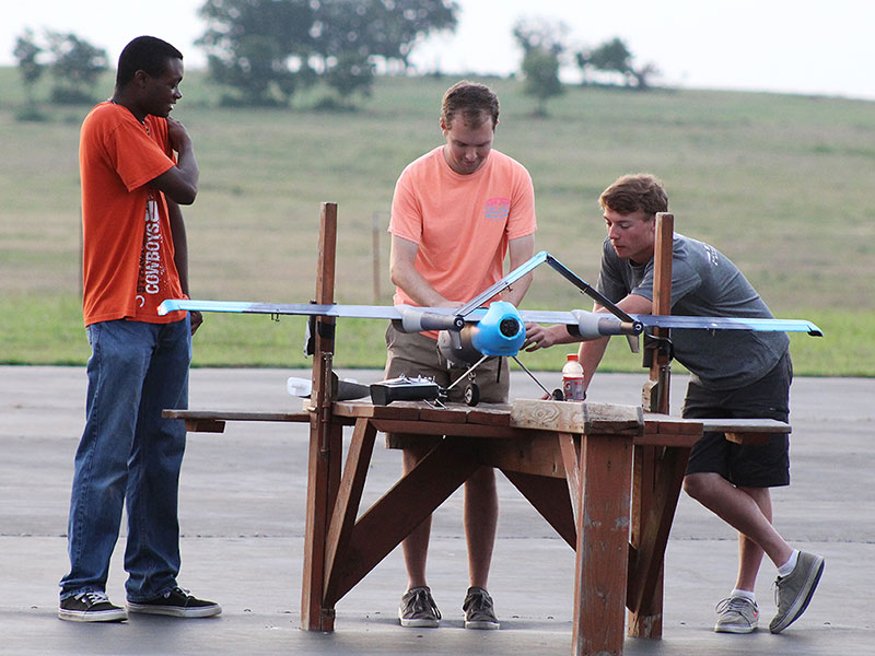 Students perform research with a drone.