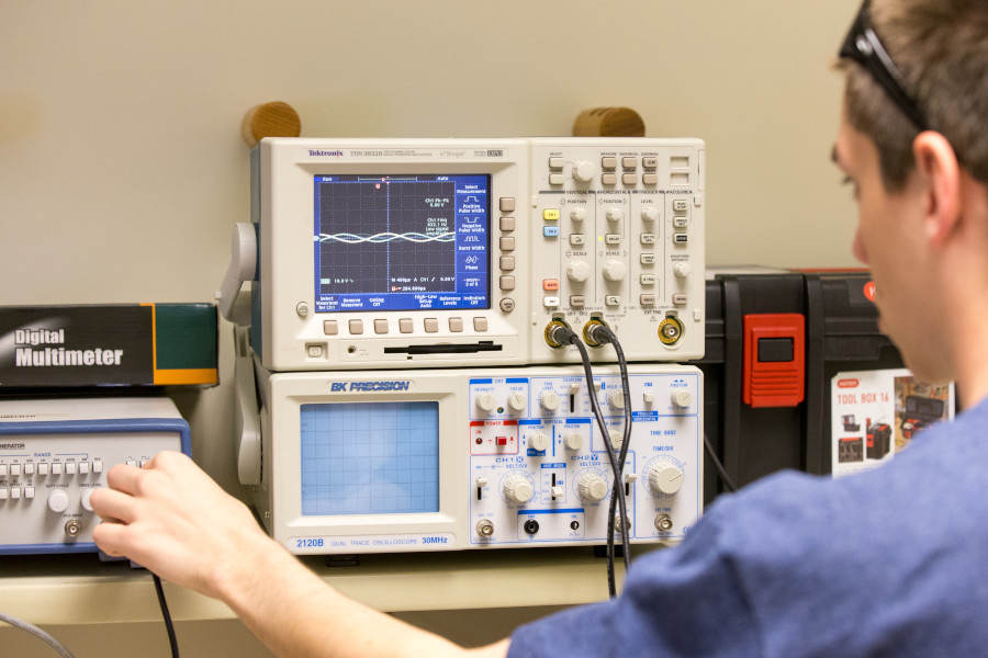 OSU student takes a reading using an oscilloscope