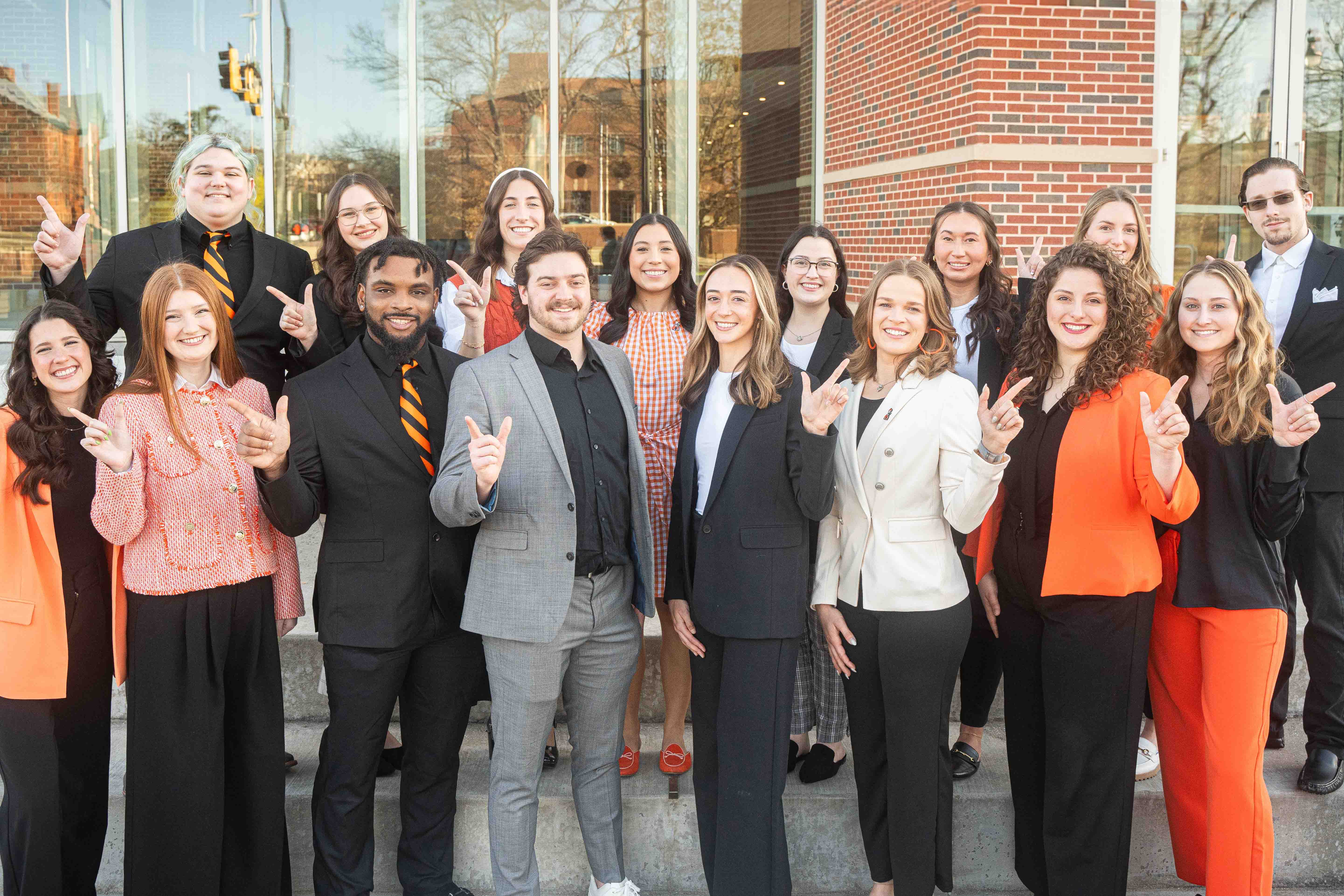 Large group photo, smiling students dressed professionally
