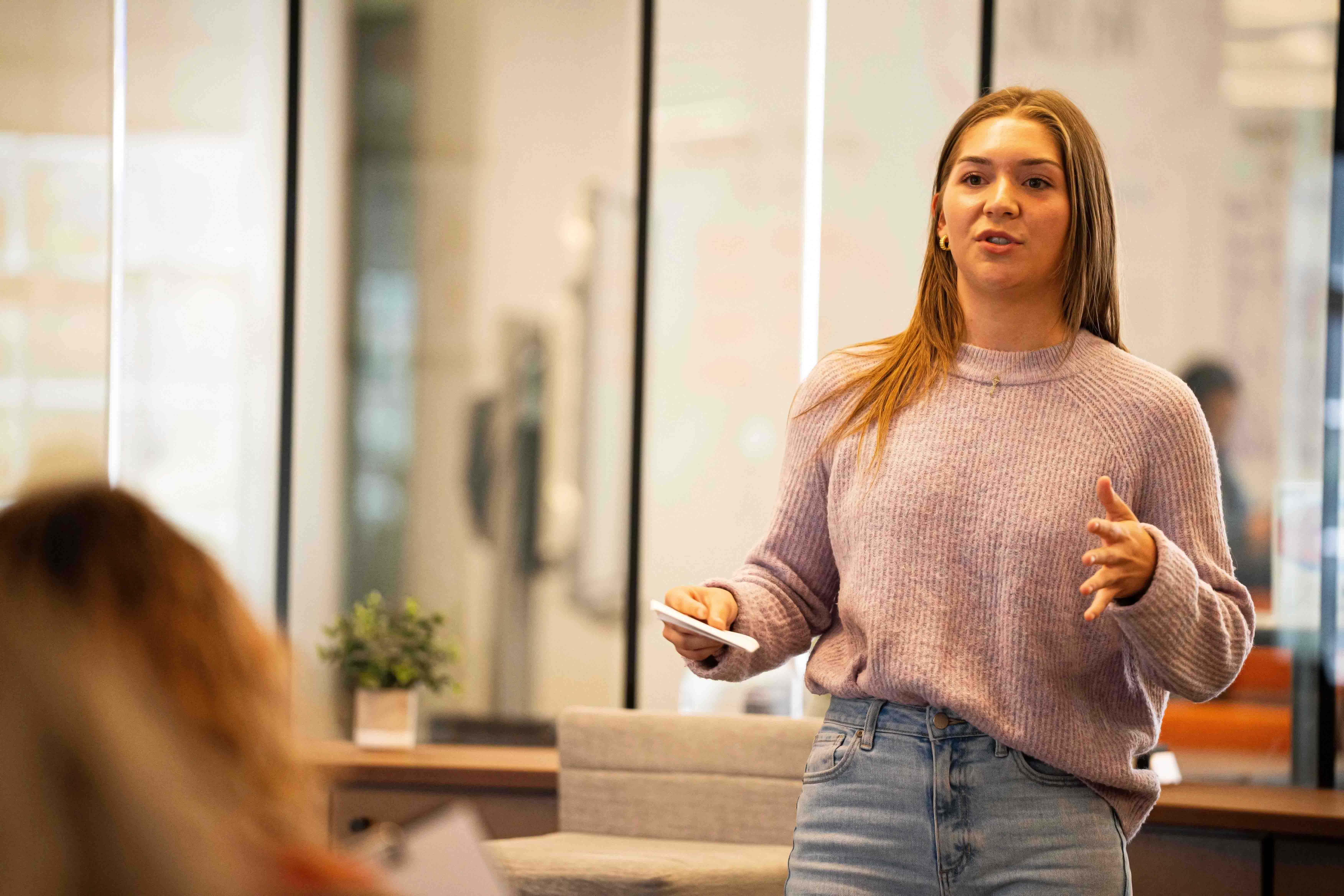 Female student giving a presentation.