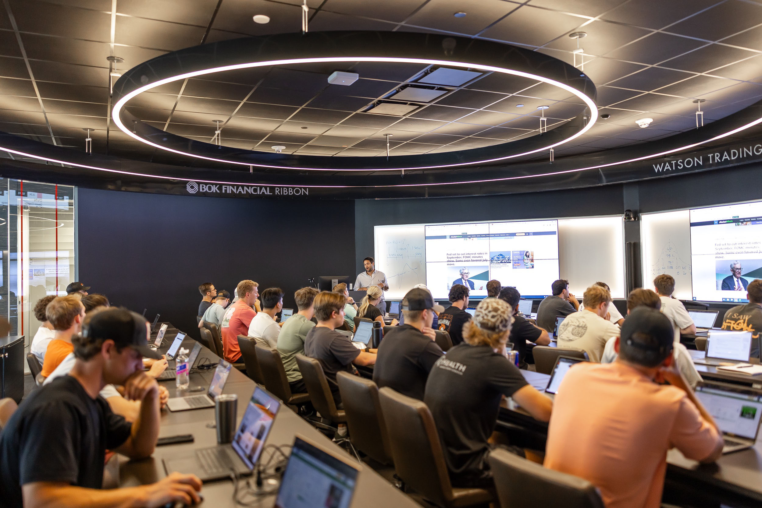 Student sit in classroom listening to professor